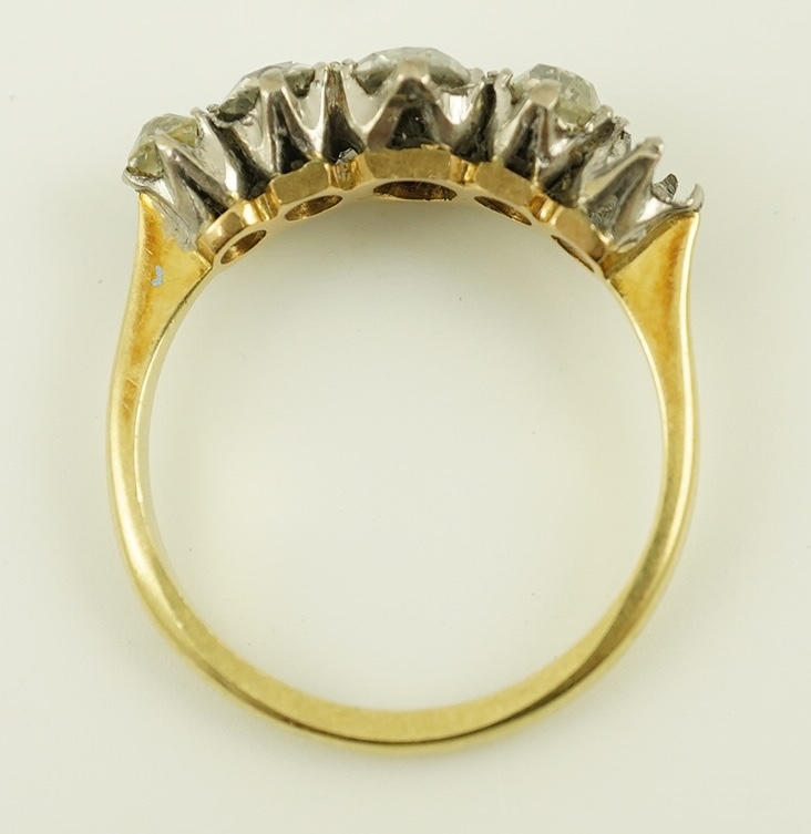 An early 20th century 18ct gold, platinum and graduated five stone old mine cut diamond set half hoop ring(one stone missing)